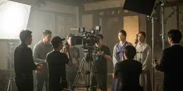 Behind-the-scenes K-drama production with crew and actors, showcasing the collaborative filmmaking process.